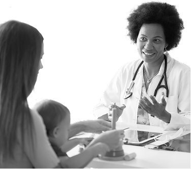 Pediatrician speaking with a parent and child